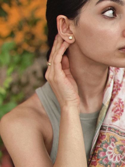 A detail shot from the Pondicherry series, focusing on the simple earring and neckline.
