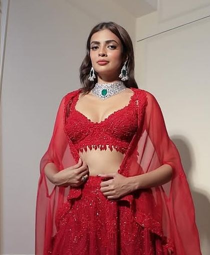 The perfect 2026 bride in a classic red lehenga. Her style is minimal, her presence unforgettable, paired with our signature diamond and emerald choker.