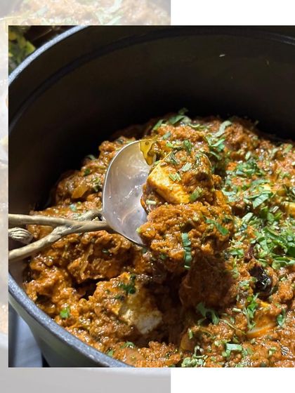 A close-up of our rich and flavourful chicken curry. Made with a blend of aromatic spices and garnished with fresh cilantro, it's a comforting and delicious main course.