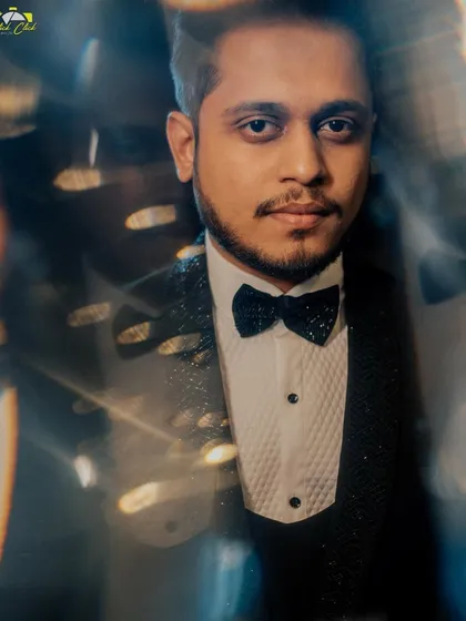 A sharp, handsome portrait of the groom, Niraj, with a creative reflection effect that adds depth.