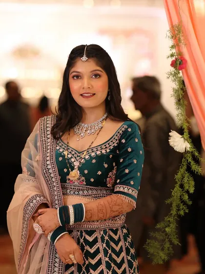 A portrait of the bride looking radiant and happy. The makeup is blended seamlessly, creating a look that is both glamorous and timeless.