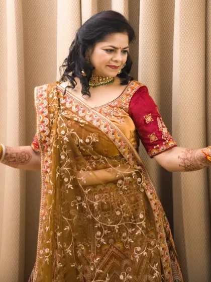 A candid, dancing pose in the traditional lehenga. This captures a moment of celebration and movement.