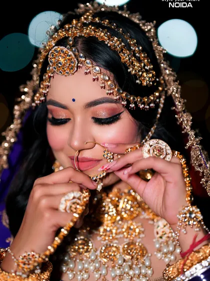 A detailed close-up of a Rajasthani bride's jewelry and makeup. Our courses cover the cultural significance and application techniques for different regional bridal styles.