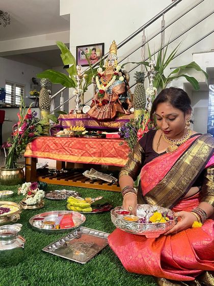 Our client performs the pooja rituals, her traditional silk saree adding to the sanctity and beauty of the moment.