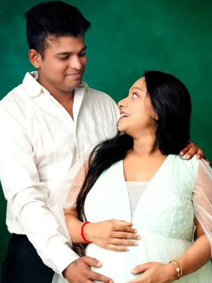 A sweet and loving look between a couple, with the mom-to-be in our mint green gown.