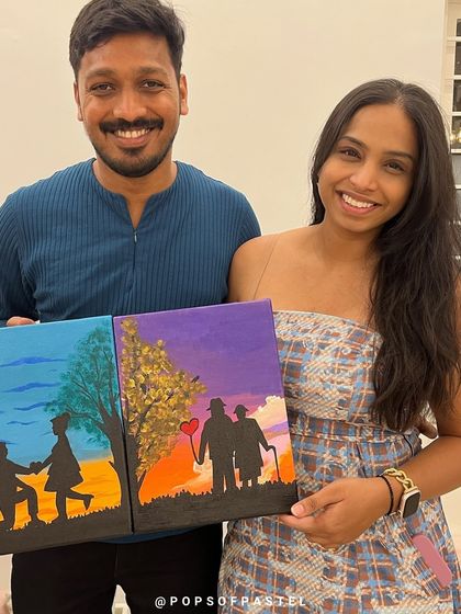 A happy couple shows off the collaborative painting they created during our special Valentine's Day sip-and-paint event.