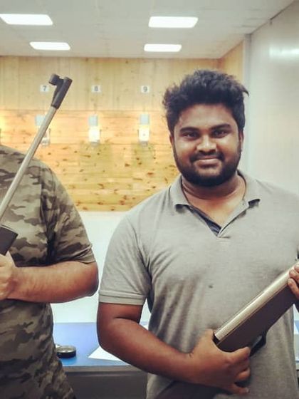 Two friends pose with their sports-grade air rifles inside our 10-meter range. Our walk in guest shooting sessions are perfect for a spontaneous and fun afternoon.