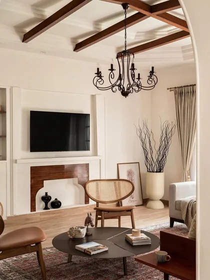Another view of the living room, highlighting the blend of antique-style furnishings with modern needs like the integrated television. This balance is key to creating timeless, livable spaces.