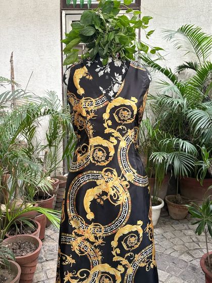 A detailed shot of the black and gold maxi dress. The focus on a clean cut ensures that the bold print remains the hero of the outfit, creating a sophisticated and timeless piece.