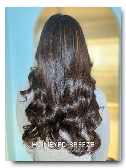 Honeyed Breeze is a light, airy color that combines a soft brown base with delicate, honey-blonde highlights. This look is designed to catch the light and create beautiful, natural-looking movement.