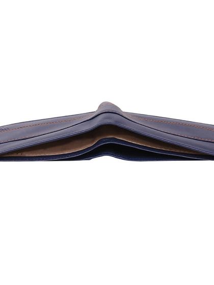 A top-down view of the navy blue leather wallet, illustrating its slim profile when folded. This angle highlights the fine grain of the genuine leather used in its construction.
