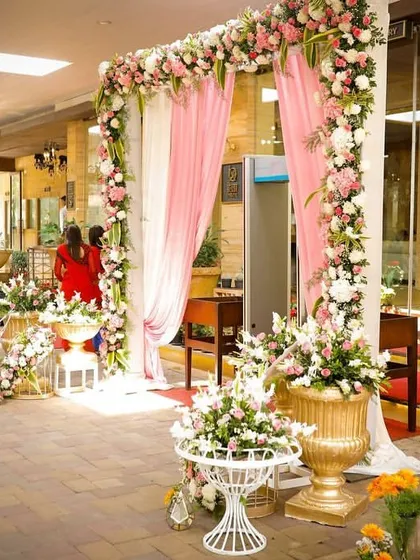 We transformed the entire portico of the hotel into a floral wonderland to welcome guests. The pink and white theme with large golden urns created a feeling of luxury and celebration.