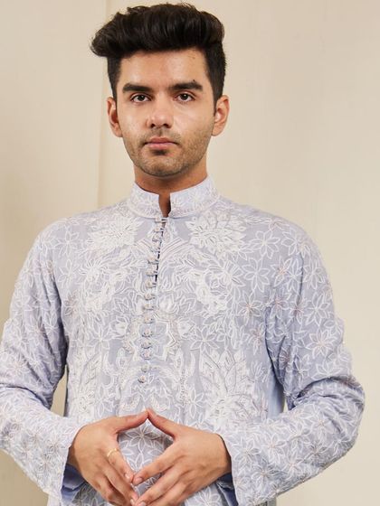 A portrait in the lavender kurta, highlighting the intricate embroidery that covers the entire garment.