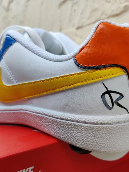 A detail shot of the heel of the Naruto custom Nike Court Royales, featuring my signature.