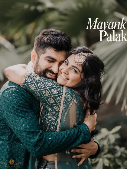 A warm, happy hug between Palak and Mayank at their Rishikesh mehndi. The lush green background complements the couple's emerald outfits perfectly.