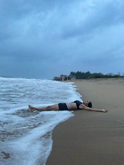 Lying in Savasana on the beach, allowing the waves to wash over me. This is a love letter to Mother Earth, expressing my deep gratitude and desire to live in harmony with nature.