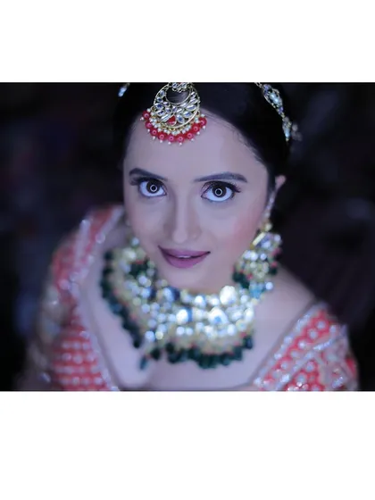 For this North Indian reception look, we went for full glam. I created a soft, shimmery pink eyeshadow look and sculpted her features to catch the light beautifully, making her eyes the star of the show.