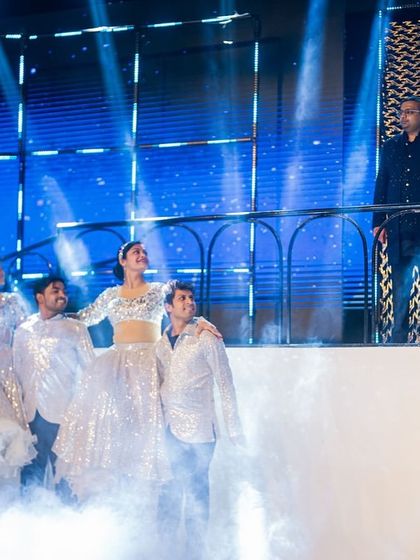 A grand reveal on a multi-level stage. We used a hydraulic lift and smoke effects for this dramatic entry, with the couple appearing on a balcony overlooking the stage as the performance began.