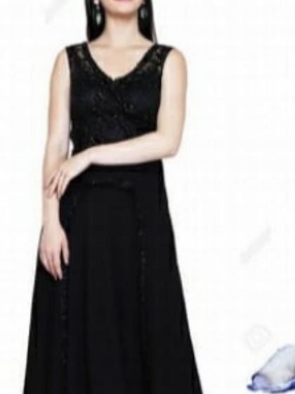 A classic black sleeveless gown with a delicately embroidered V-neck bodice. This timeless piece is a versatile addition to any wardrobe, suitable for formal dinners, receptions, and cocktail events.