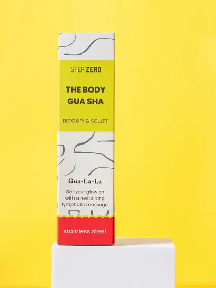 A bold, graphic shot of "The Body Gua Sha" by Step Zero, using a pedestal and a solid yellow background. This style is modern and eye-catching.