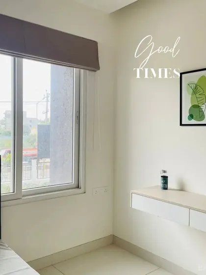 A simple and effective use of space in a bedroom, featuring a floating desk that serves as a vanity or study table without taking up floor space.