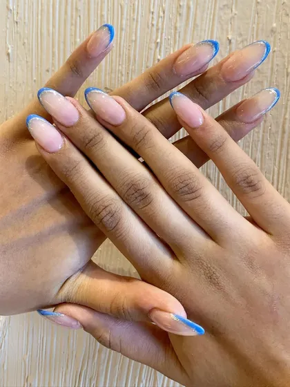 Perfect for summer, this design features a thin, bright blue French tip on a long, clear extension. It's minimalist, clean, and so chic.