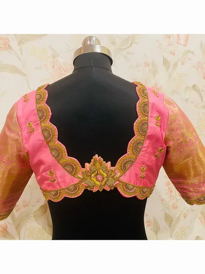 This pink bridal blouse features a beautifully scalloped back neckline, fully embroidered to create a stunning frame.
