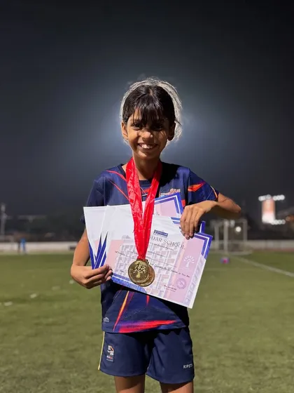 Kiana Sharma beaming with pride as she holds her two Gold medals and certificates. A fantastic result from a dedicated young athlete.
