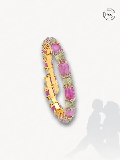 A vibrant and unique spring-style bracelet adorned with exquisite emeralds and sparkling tanzanite round rose cuts in 14k gold. Designed for versatility, it transitions effortlessly between Indian and Western outfits.