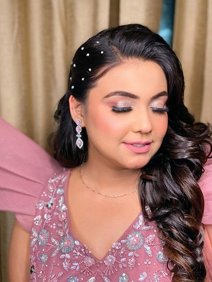 A beautiful close-up of this party makeup look. The eyes have a soft pink shimmer, and the hair is adorned with delicate pearl pins.