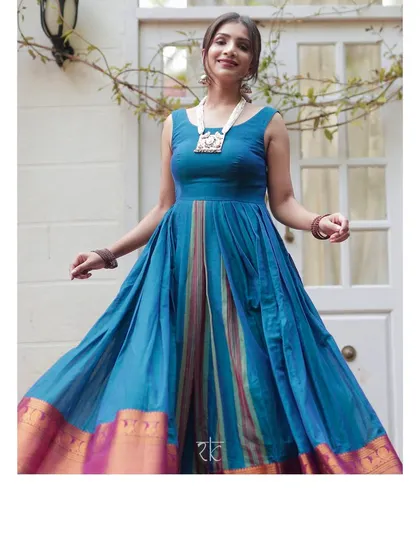 A joyful Yale blue dress with a traditional silk border, perfect for any festive celebration. Its full skirt has a beautiful twirl.