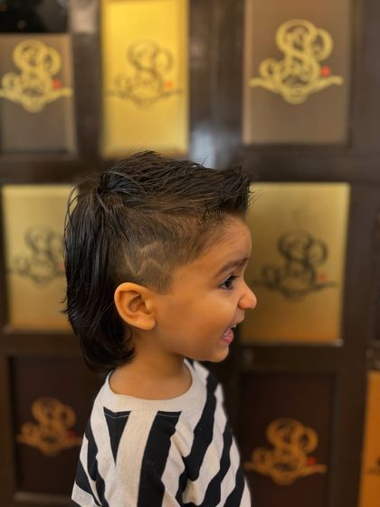 We even add custom designs. This side view shows the sharp line and heart detail we added to this young client's fade for an extra touch of personality.