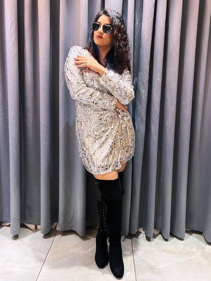 All set to welcome 2024 in this sparkly dress and boots. My New Year's Eve shows are always extra special.