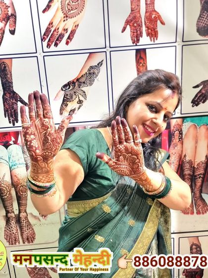 A happy client showcasing her beautiful mehndi design.