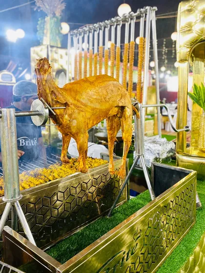 A close-up of the whole roasted lamb on a spit, a true spectacle for guests and a testament to our commitment to creating memorable culinary experiences.