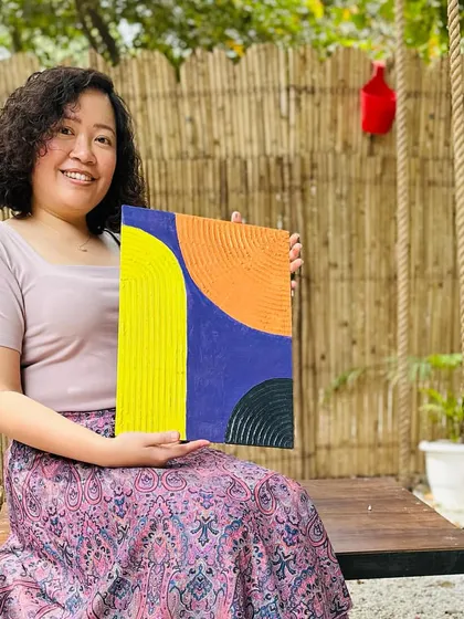 Another happy artist with her vibrant and bold texture painting. The interplay of bright yellow, orange, and deep blue creates a stunning abstract design. It was a joy to see her explore this medium.
