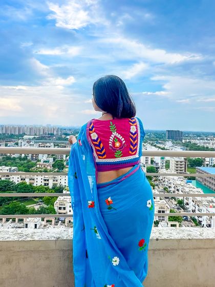 Another shot of the blouse against the cityscape. This kind of statement piece is perfect for when you want your saree look to feel special and personalized.