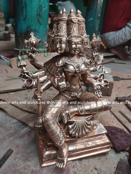 A work-in-progress photograph of a Gayatri icon. The freshly cast bronze is being detailed and polished in our workshop, revealing the intricate beauty of the South Indian art form.