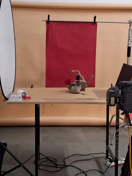 The full studio setup for our artistic still life fragrance shoot, showing the camera, lights, and backdrop.
