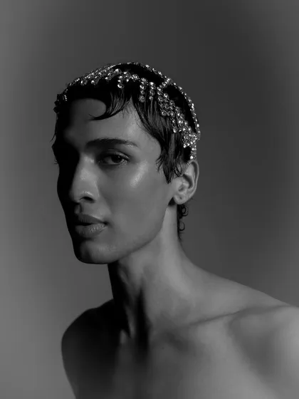 A classic black and white portrait from a Calvin Klein project. The image uses sharp, directional light to sculpt the model's features, showcasing a timeless and refined approach to beauty photography.