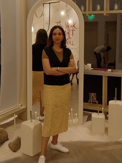 Here I am inside the completed installation, standing before a mirror that reflects our design philosophy. The space was a blend of quiet elegance and playful chaos, filled with furniture that has personality and corners that hold secrets.