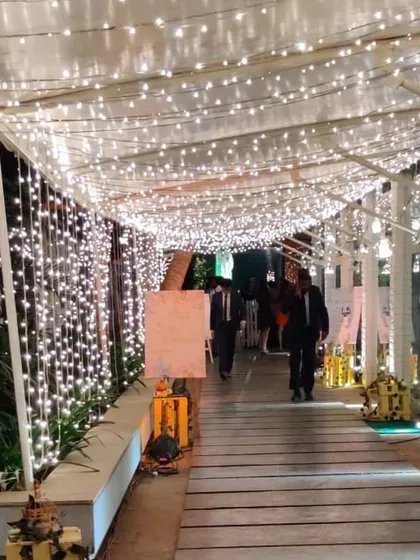The guest journey starts with the entrance. Here, I constructed a magical walkway covered entirely in fairy lights, creating an unforgettable first impression and a perfect photo opportunity for attendees of a corporate reception.