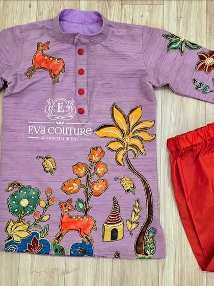 A playful Kalamkari kurta in lavender with colorful hand-painted motifs. It is paired with simple red pajamas.