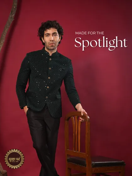 Made for the spotlight. This dark green sequined Bandhgala jacket paired with black trousers is a showstopper, designed for a groom who wants to shine.