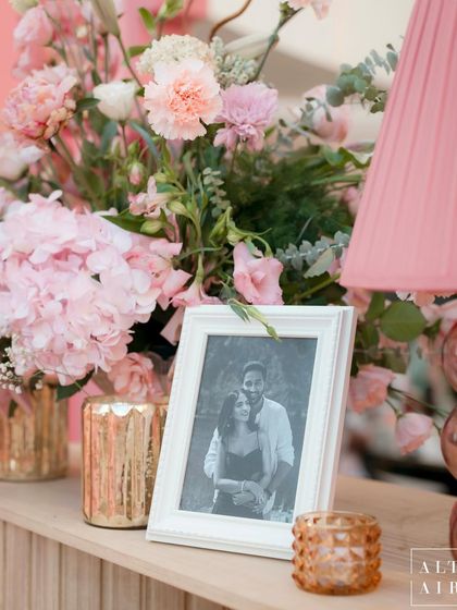 A personal touch at the 'Echoes of Pink' wedding in Doha. A framed photo of the couple sits among the flowers, reminding everyone of the love story at the center of the celebration.