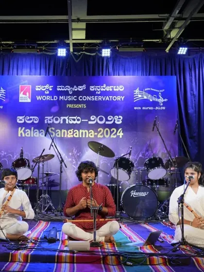 The full ensemble for the Raag Hamsadhwani performance, showing students and their guru sharing the stage.