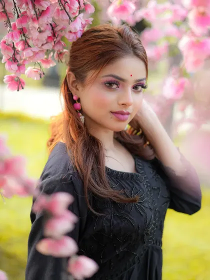 A soft, dreamy portrait using artificial flowers to create a beautiful foreground and background blur. This creative studio setup is perfect for beauty shots or romantic-themed lookbooks.