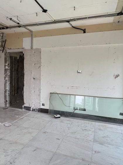 The transformation begins. This is the living space before our intervention, a bare shell with exposed wiring and unfinished surfaces, waiting to be reimagined into a bold and balanced home.