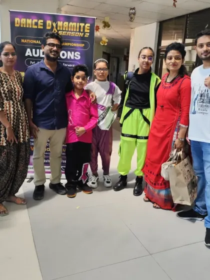 A group photo with students and their proud parents at the national dance championship auditions. Their support is the backbone of our students' success.