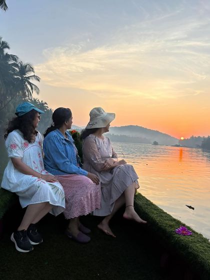 Three friends enjoying the golden hour during a sunset boat ride in Honnavar. A perfect, picturesque moment.